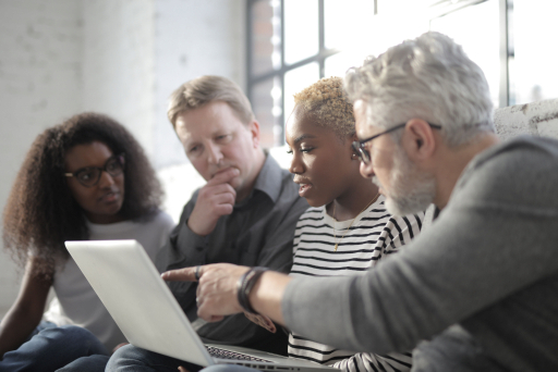 Business team reviewing custom software scope and cost drivers on a laptop
